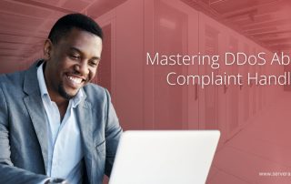 DDoS abuse complaint handling banner with a professional smiling at a laptop